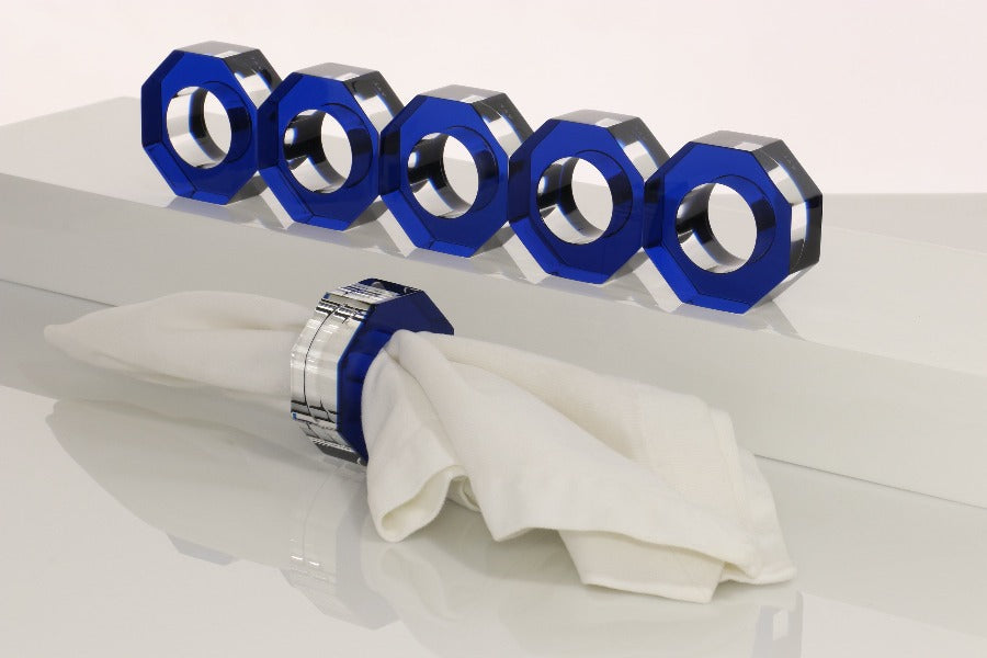 Alexandra Von Furstenberg Acrylic Dinner Napkin Rings in Sapphire showing 6 rings with a napkin in one. 