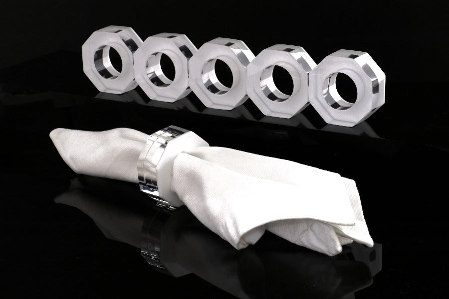 Alexandra Von Furstenberg Acrylic Dinner Napkin Rings in White showing 6 rings with a napkin in one. 