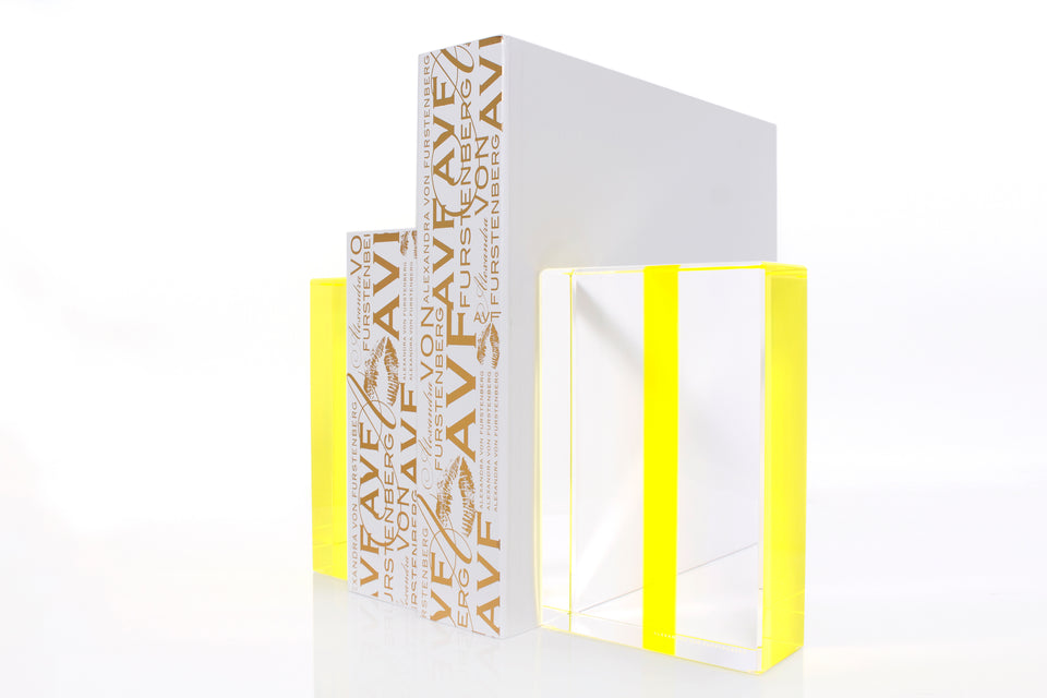 Alexandra Von Furstenberg Acrylic Block Chapter Bookends in yellow color showing books in between. 