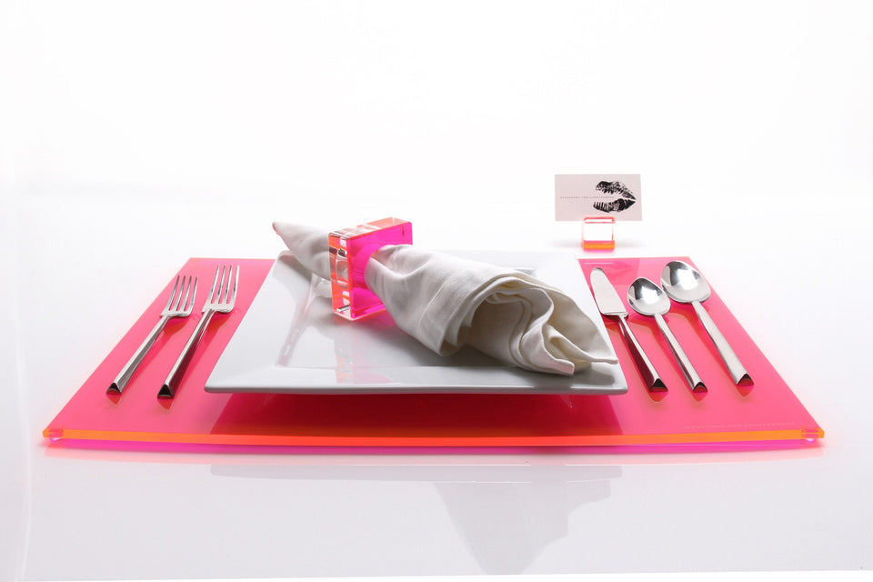 Alexandra Von Furstenberg Acrylic Rectangle Placemat set in Pink with table setting including acrylic napkin ring and acrylic place card holder 