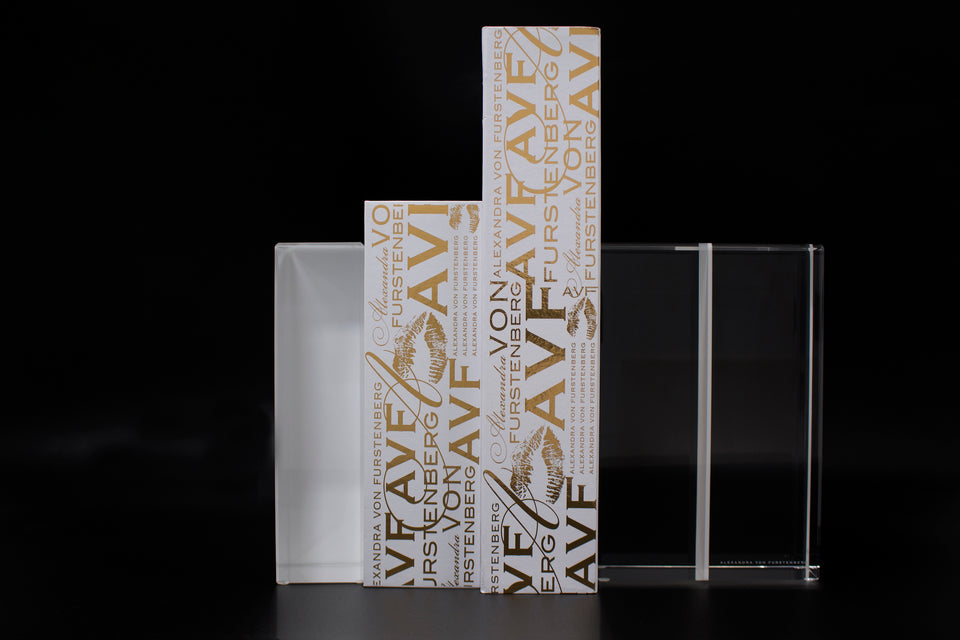 Alexandra Von Furstenberg Acrylic Block Bookends in white color showing books in between. 