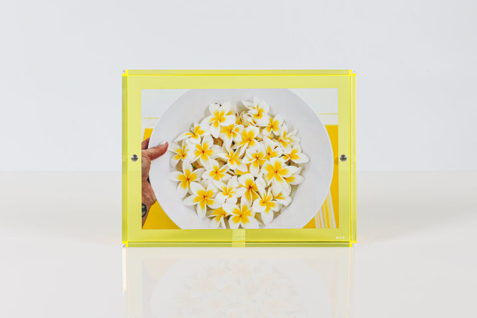Yellow frame in 5x7. Luxury lucite picture frame in yellow holding a picture of yellow flowers. alexandra von furstenberg accessories