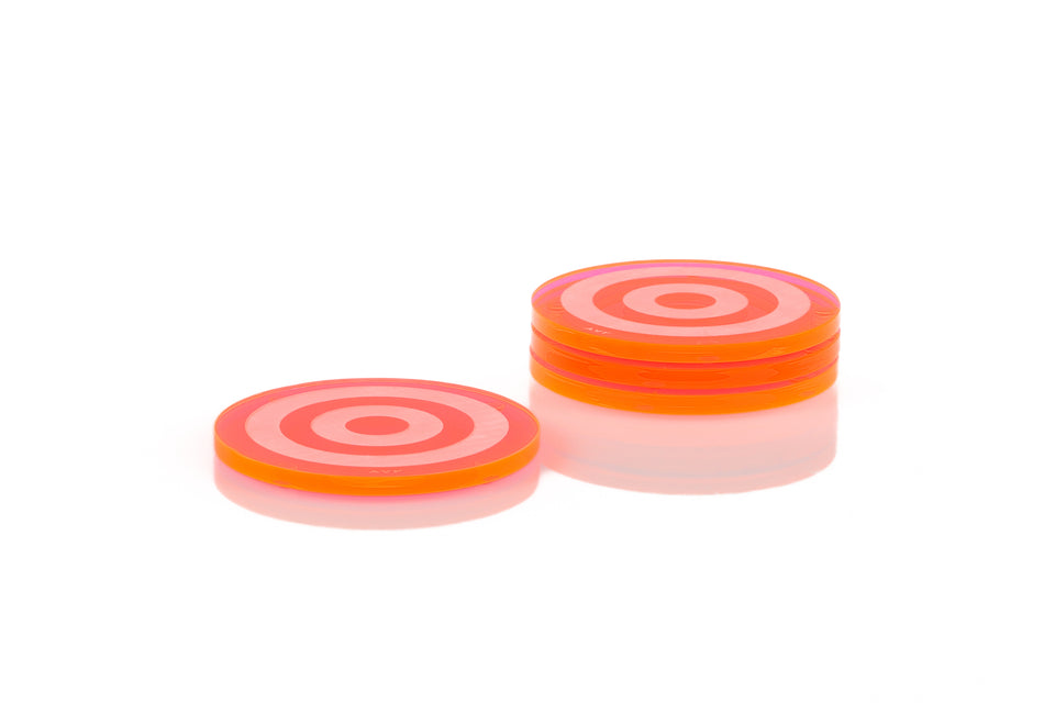 Set of 4 pink round acrylic coasters with a bullseye pattern set on a white background