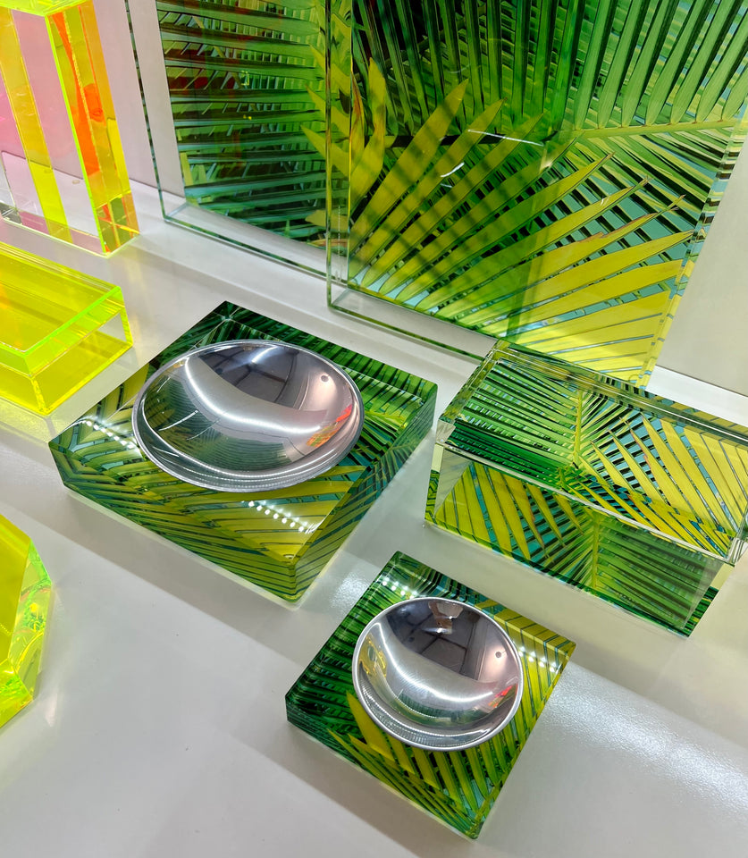 Aluminum dish liner in palm print candy bowls. Palm print tray is also displayed on the table. 