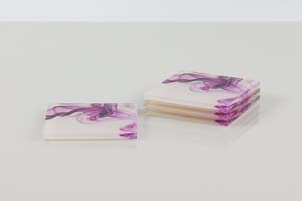 Alexandra von furstenberg acrylic magenta smoke print square coasters. three stacked and one solo. 