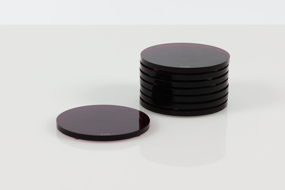 Circular round coasters by alexandra von furstenberg in amethyst stack of 8 on a white background. 
