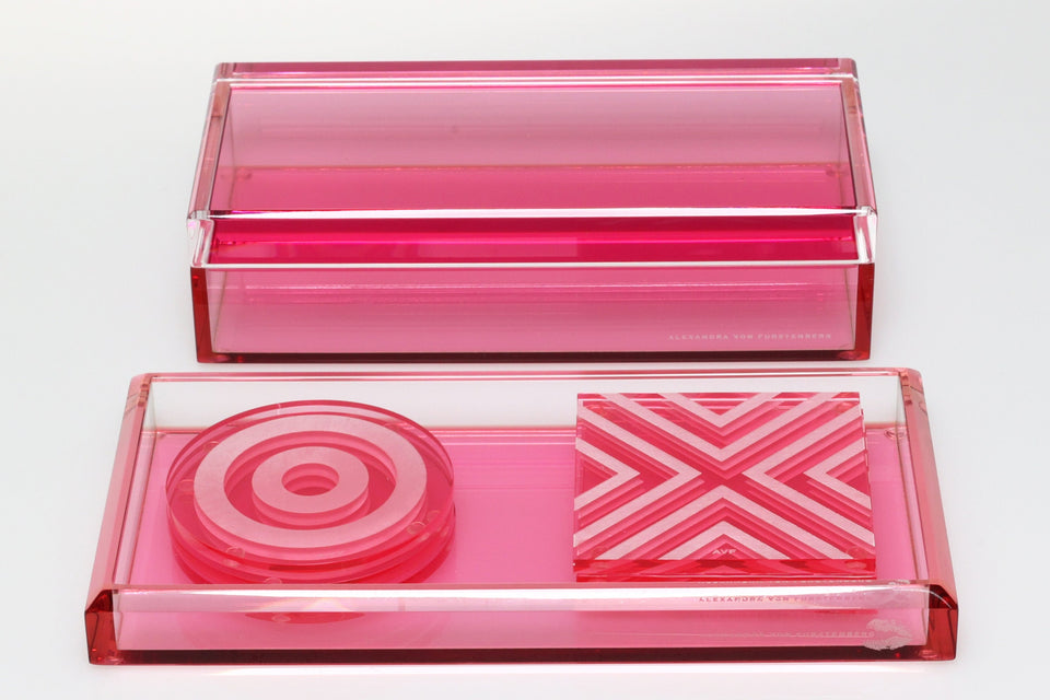 Tulip coaster sets resting in a valet tray. Sitting in front of a acrylic storage box. 