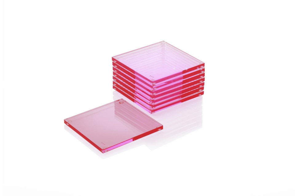 Alexandra Von Furstenberg Acrylic lucite drink coasters in Rose stacked in a pile.