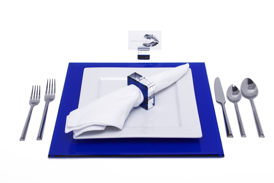 Alexandra Von Furstenberg Acrylic Square Placemat set in Sapphire with table setting including acrylic napkin ring and acrylic place card holder 