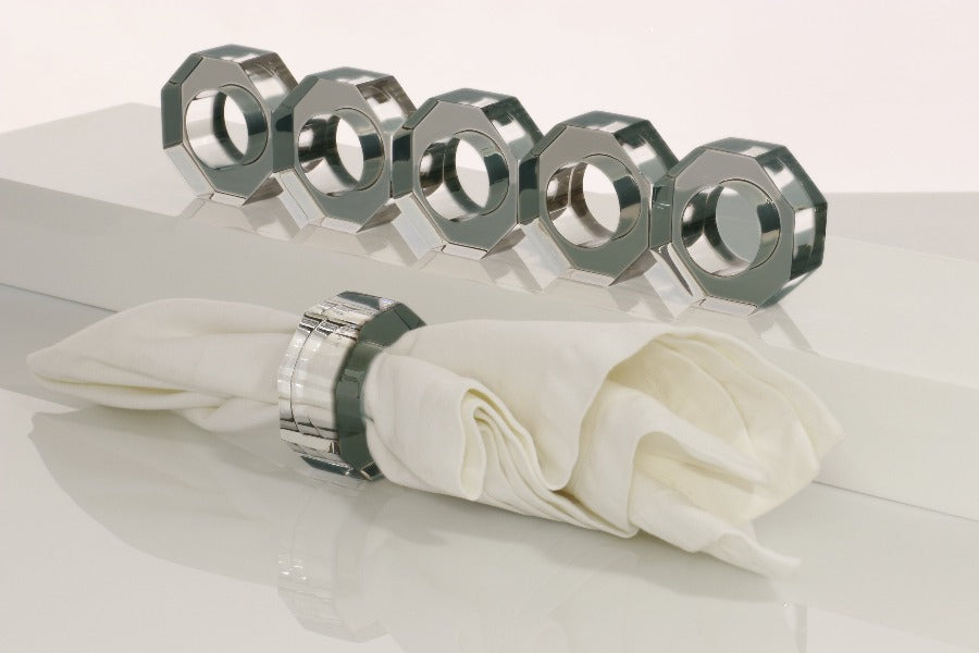 Alexandra Von Furstenberg Acrylic Dinner Napkin Rings in Slate Grey showing 6 rings with a napkin in one. 