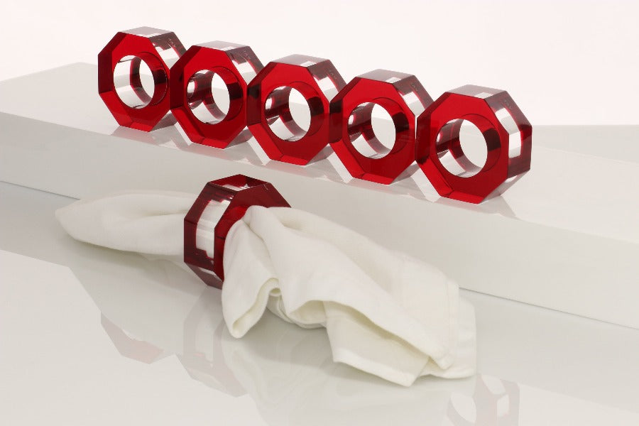 Alexandra Von Furstenberg Acrylic Dinner Napkin Rings in Ruby showing 6 rings with a napkin in one. 