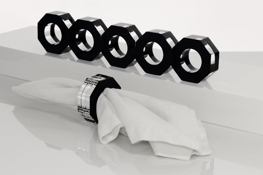 Alexandra Von Furstenberg Acrylic Dinner Napkin Rings in black showing 6 rings with a napkin in one. 