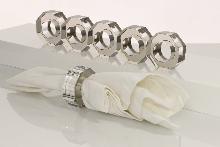 Alexandra Von Furstenberg Acrylic Dinner Napkin Rings in bronze showing 6 rings with a napkin in one. 
