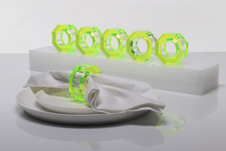 Alexandra Von Furstenberg Acrylic Dinner Napkin Rings in neon green showing 6 rings with a napkin in one. 