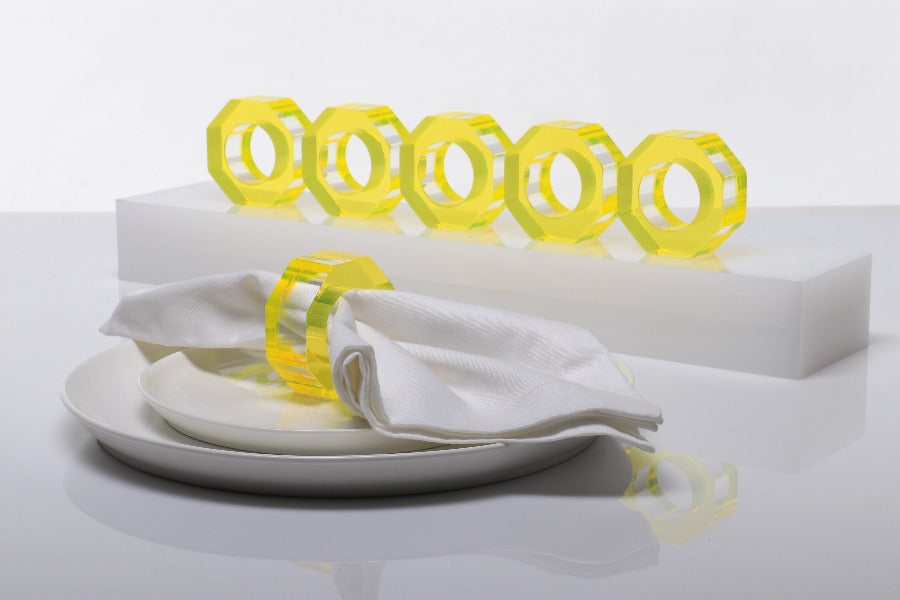 Alexandra Von Furstenberg Acrylic Dinner Napkin Rings in Yellow showing 6 rings with a napkin in one. 
