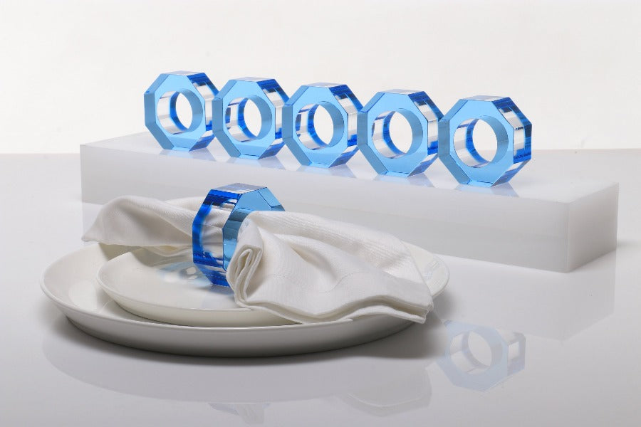 Alexandra Von Furstenberg Acrylic Dinner Napkin Rings in lagoon showing 6 rings with a napkin in one. 