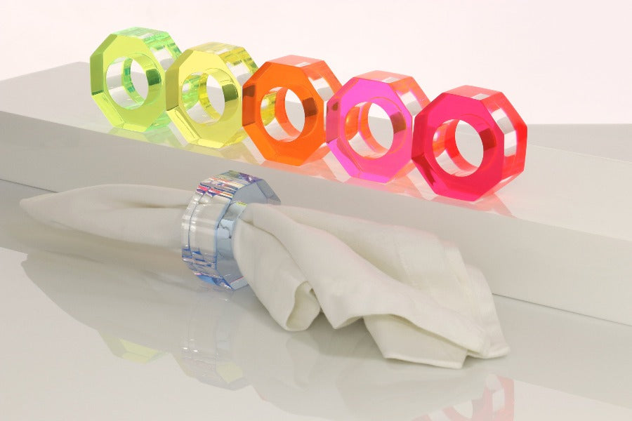 Alexandra Von Furstenberg Acrylic Dinner Napkin Rings in assorted neon colors showing 6 rings with a napkin in one. 