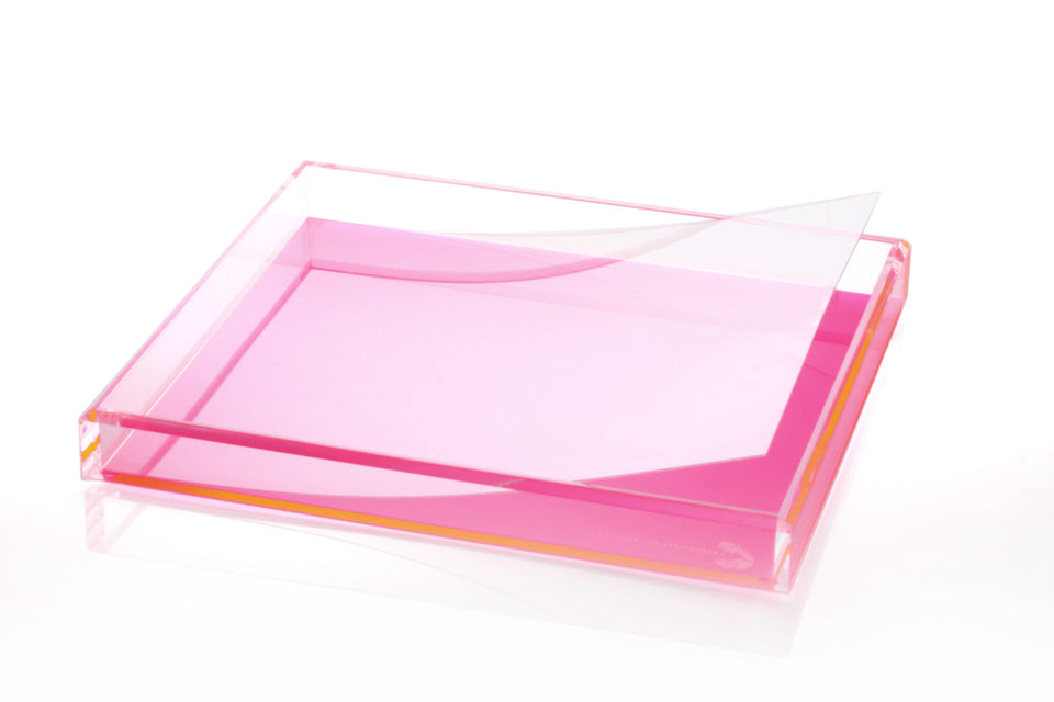 A clear plastic liner designed to fit inside a pink tray, displayed against a white background.