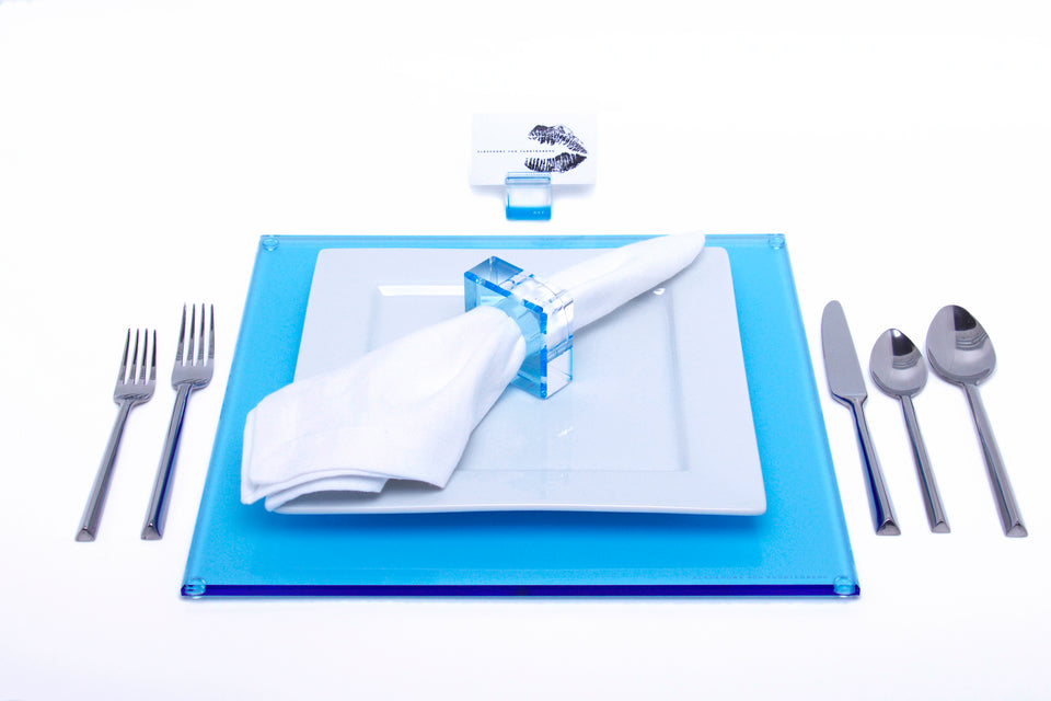 Alexandra Von Furstenberg Acrylic Square Placemat set in Lagoon with table setting including acrylic napkin ring and acrylic place card holder 