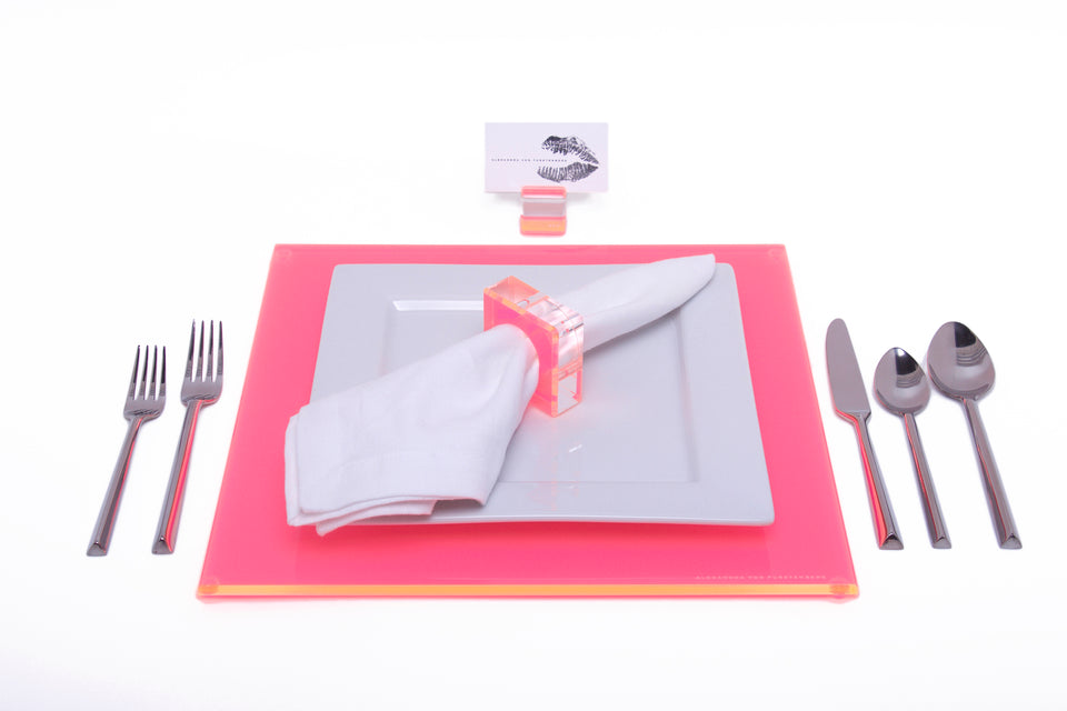 Alexandra Von Furstenberg Acrylic Square Placemat set in Pink with table setting including acrylic napkin ring and acrylic place card holder 