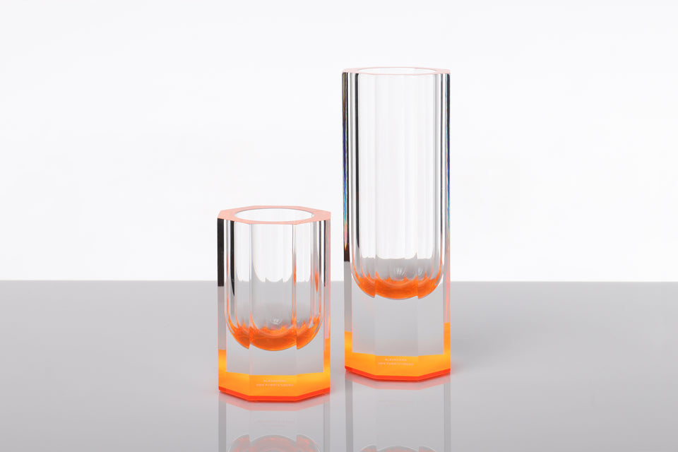 Alexandra Von Furstenberg Acrylic Bolt hexagon bud vases in orange shown in two sizes. 