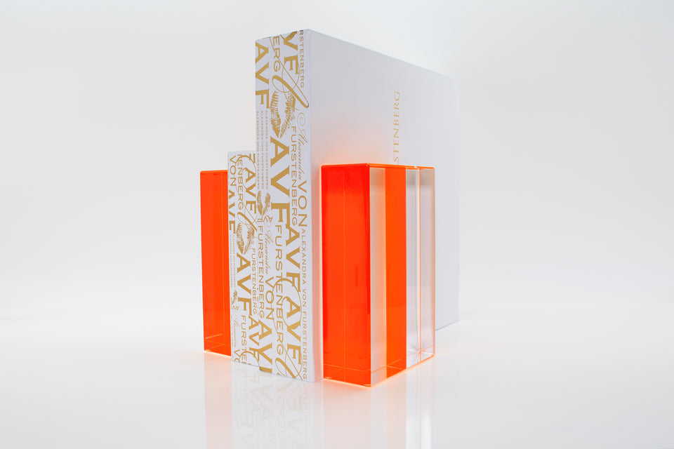 Alexandra Von Furstenberg Acrylic Block Bookends in orange color showing books in between. 