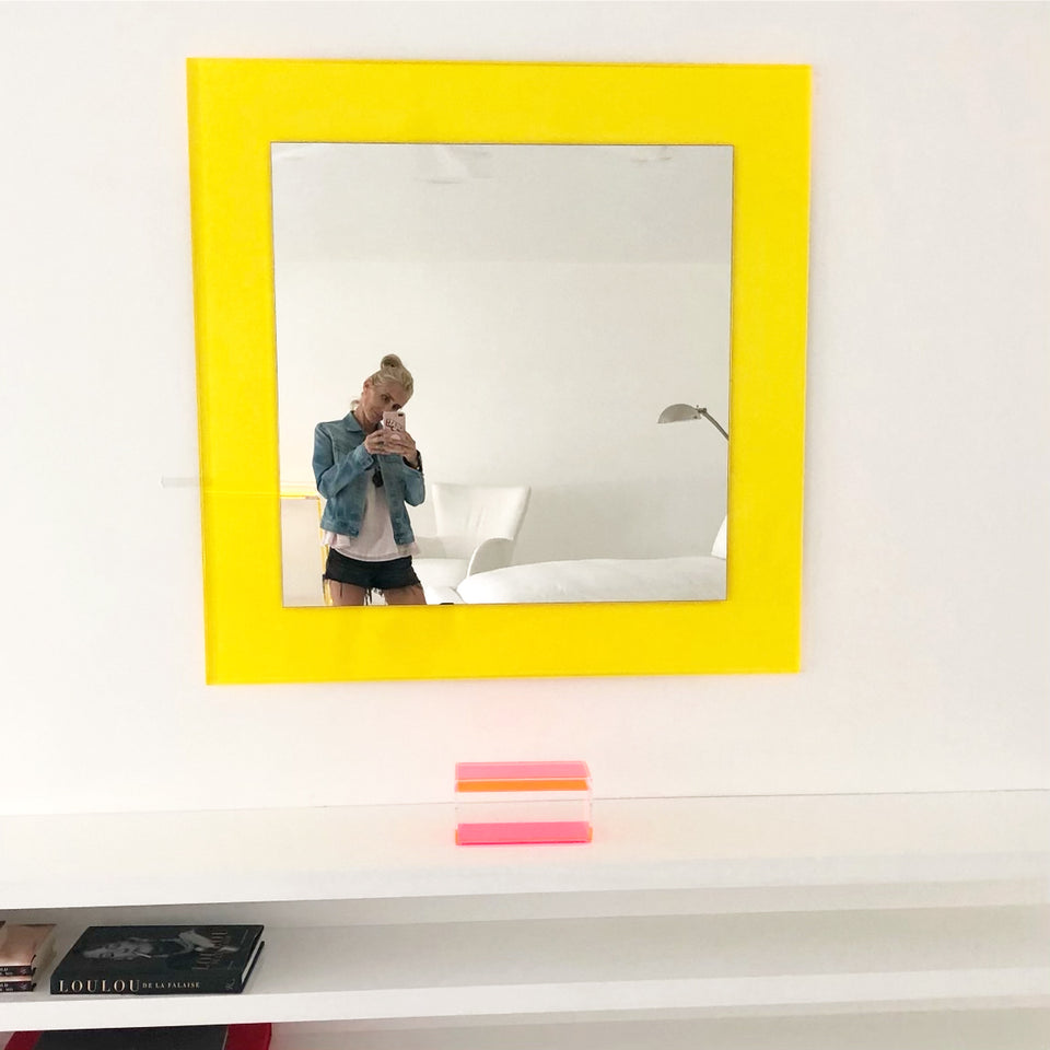 Alexandra Von Furstenberg Acrylic Square Yellow Large Wall Mounted mirror showing someone taking a picture in mirror.