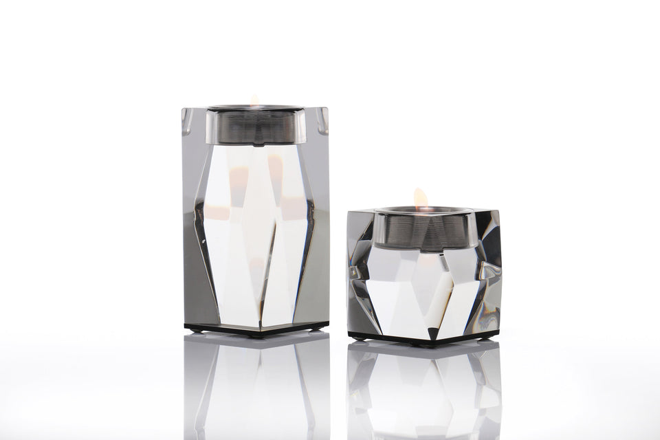 Pair of acrylic luxury votive bronze candleholders one is short one is tall set against a white background