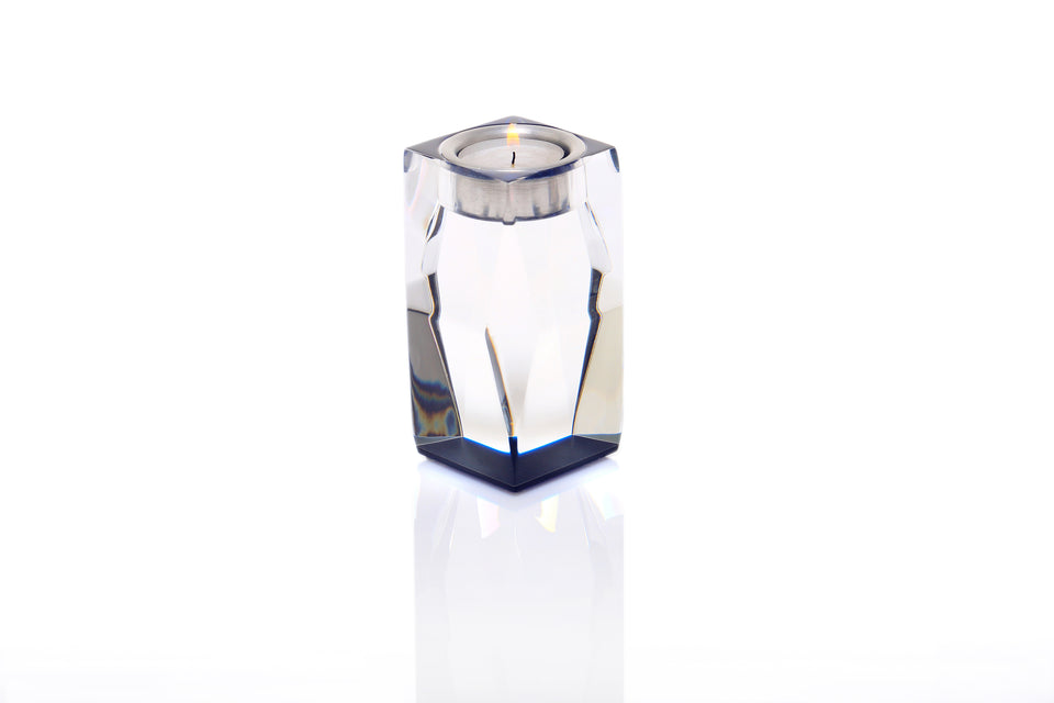 Sapphire tall candle holder with a lit votive candle on a white background. 