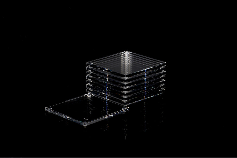 Alexandra Von Furstenberg Acrylic lucite drink coasters in clear stacked in a pile.