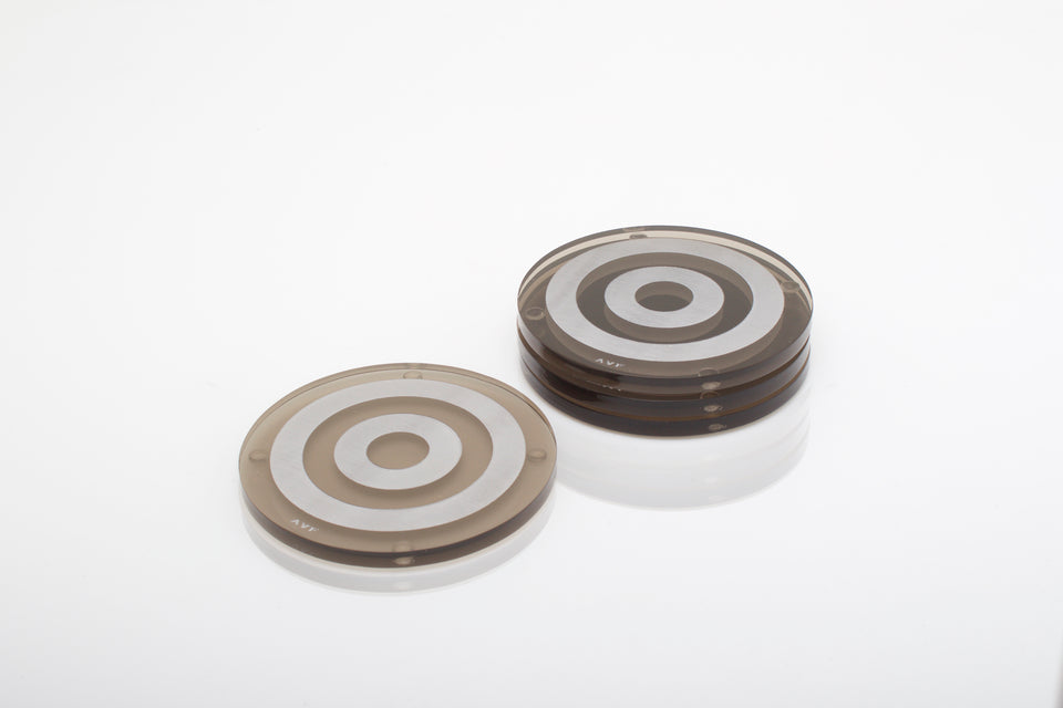 Alexandra Von Furstenberg Acrylic lucite bullseye drink coasters in bronze stacked in a pile set of 4
