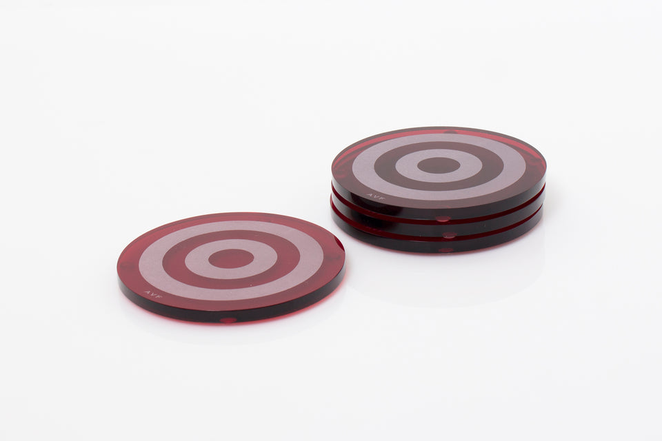 Alexandra Von Furstenberg Acrylic lucite bullseye drink coasters in ruby stacked in a pile set of 4