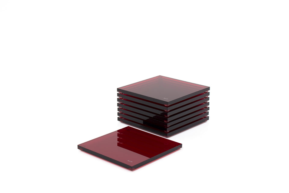 Alexandra Von Furstenberg Acrylic lucite drink coasters in ruby stacked in a pile.