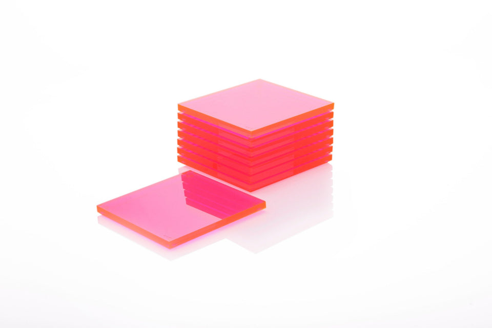 Alexandra Von Furstenberg Acrylic lucite drink coasters in pink stacked in a pile.